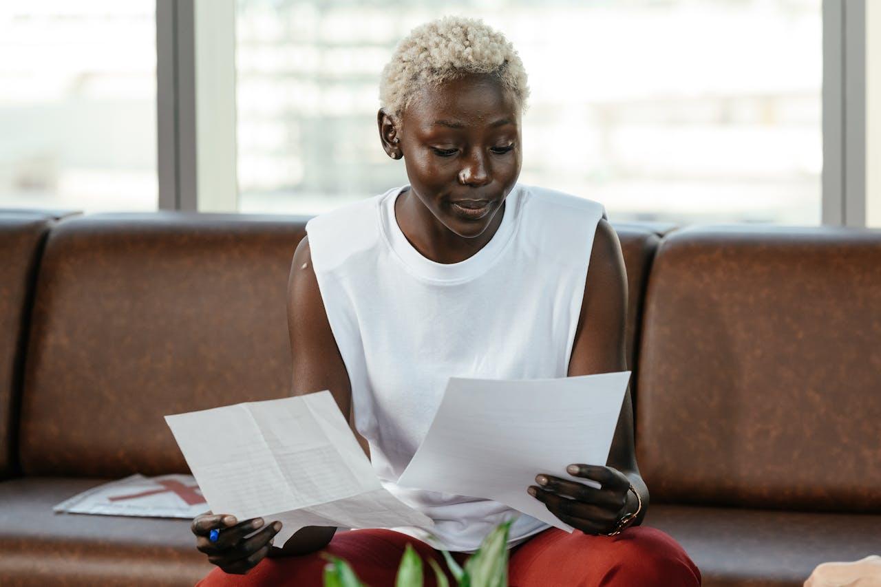 Woman reviewing documents on a couch