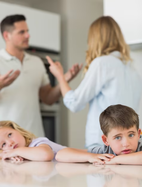 A man and two children are in the kitchen.