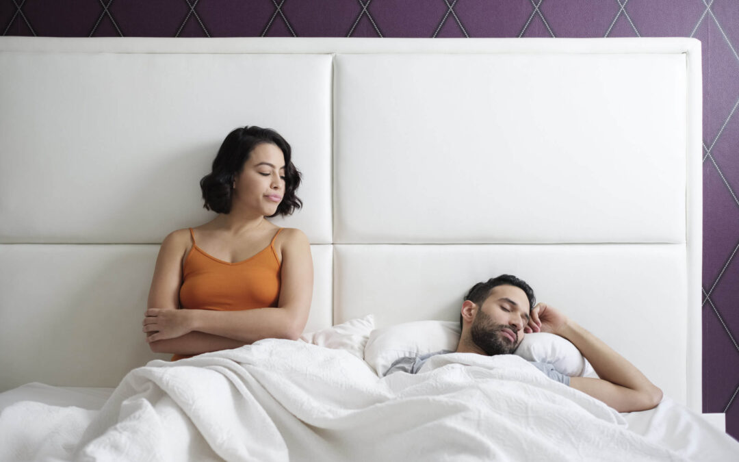 A man and woman are laying in bed together, but the wife is considering a divorce due to her husband's addiction issues.