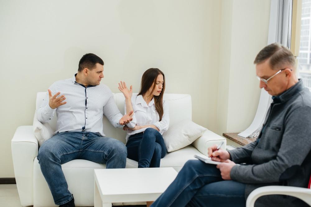 A group of people relaxing on a couch.