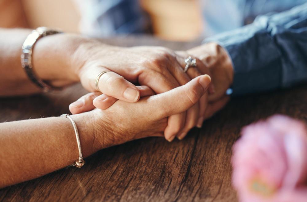 A close-up of intertwined hands.