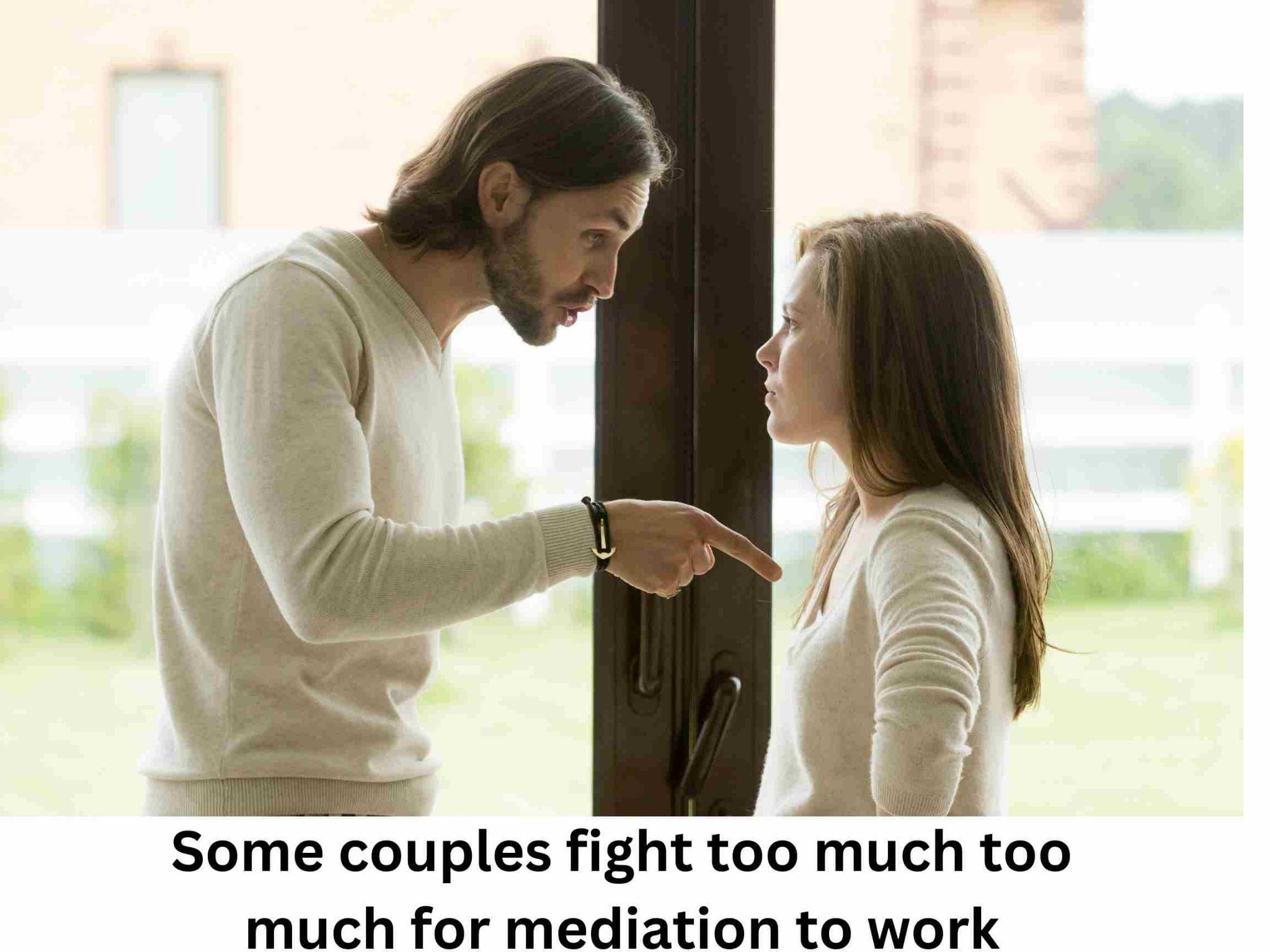 A man pointing at a woman's face.