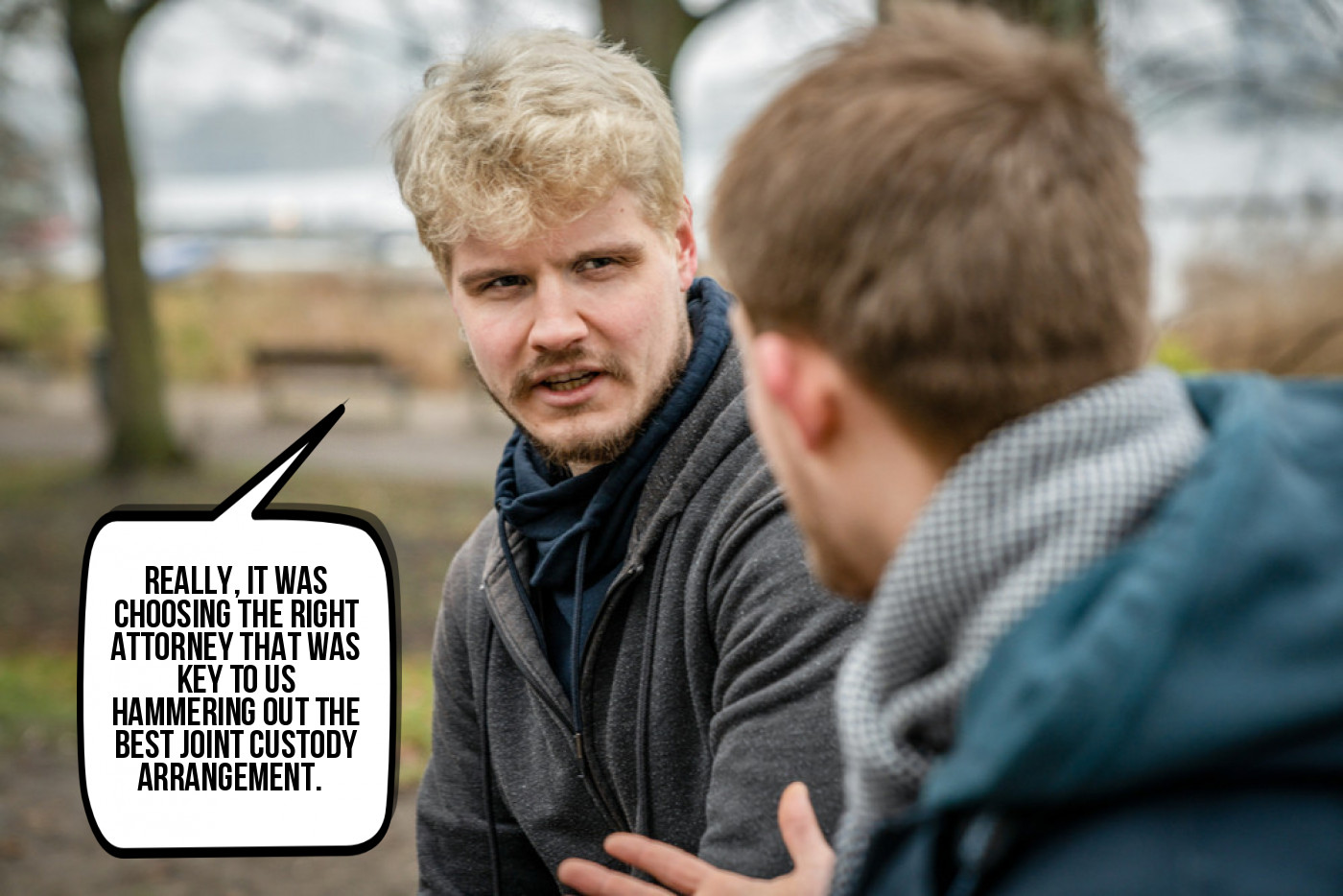 Two men engaged in a conversation outdoors, with one man appearing to be talking about what joint custody is in Texas.