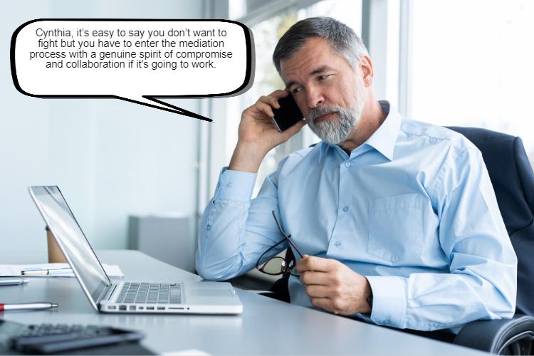 A man with a gray beard is sitting at a desk, talking on a phone while holding glasses. He appears to be engaged in a serious conversation about mediation. A laptop and office supplies are on the desk.