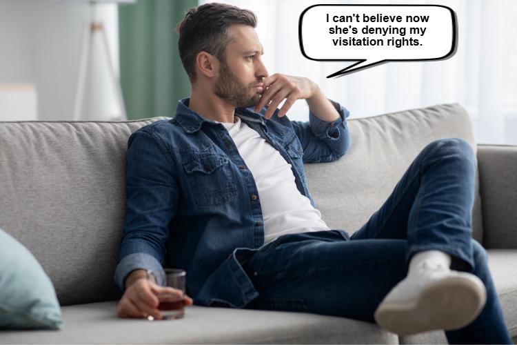 Man sitting on a couch, looking thoughtful and holding a drink. A speech bubble shows, "When can you deny visitation to the non-custodial parent? I can't believe now she's denying my visitation rights.