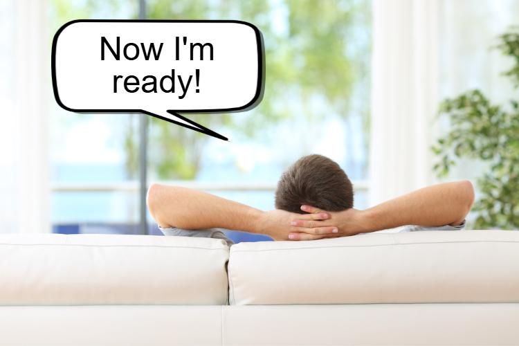 Person sitting on a couch facing away, hands behind their head. A speech bubble reads,