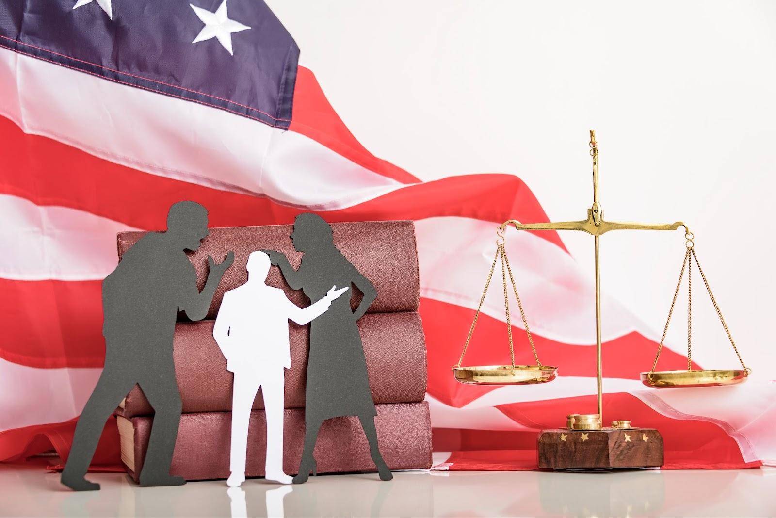 Silhouettes of three people arguing in front of an American flag, with scales of justice and legal books present, possibly depicting a scene involving a divorce attorney in Dallas, TX.